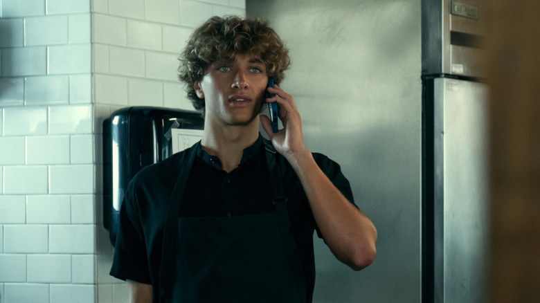 Jeremiah on the phone in an industrial kitchen on The Summer I Turned Pretty