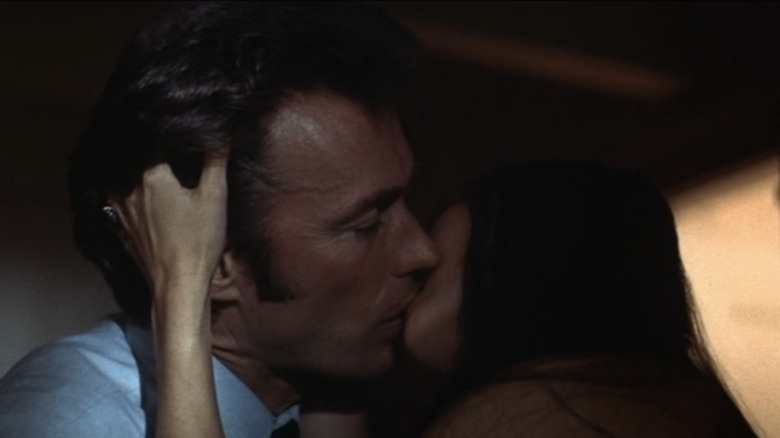 Clint Eastwood's Harry Callahan kisses a woman in Magnum Force