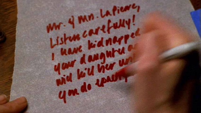 A hand writing a ransom note that reads "Mr. y Ms. LaPierre, Listen carefully! I have kidnapped your daughter and will kill her unless you do exactly..." A scene from The X-Files.