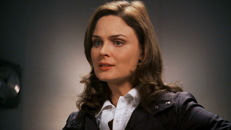 Emily Deschanel's Temperance Brennan stands against a plain background in Bones