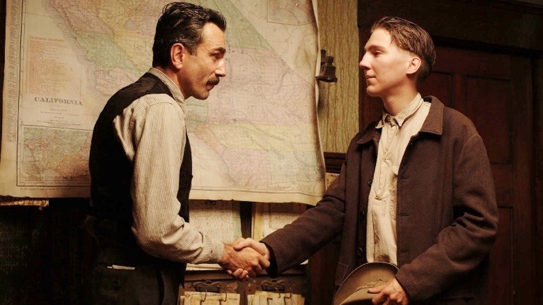 Daniel Plainview shaking Paul Sunday's hand