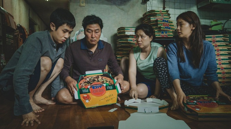 The Kim family in Parasite folds pizza boxes