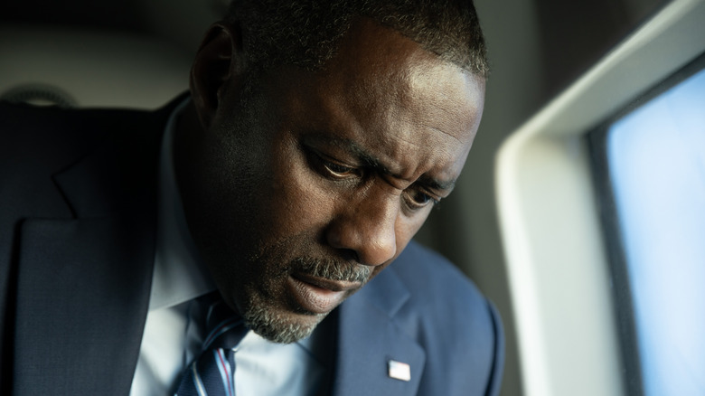 Idris Elba as the President of the United States looking pensive seated by a window in A House of Dynamite