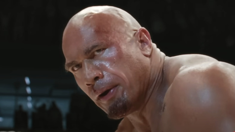Dwayne Johnson as Mark Kerr, looking tired in the ring, in The Smashing Machine