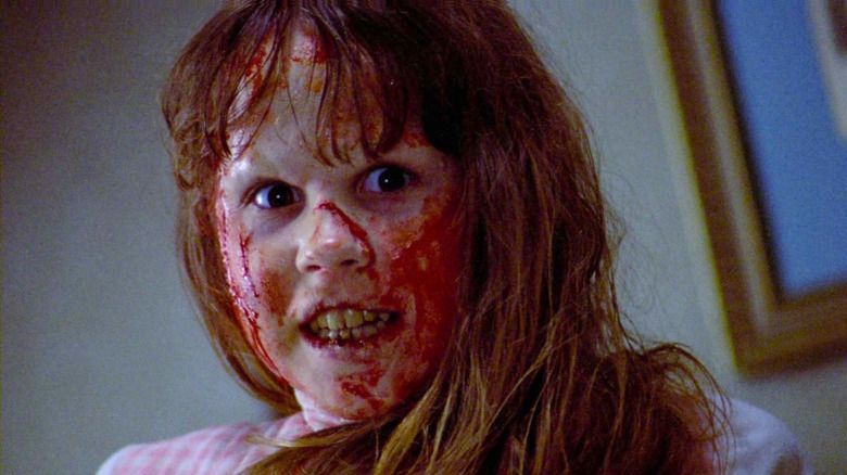 A possessed Regan smiles in The Exorcist
