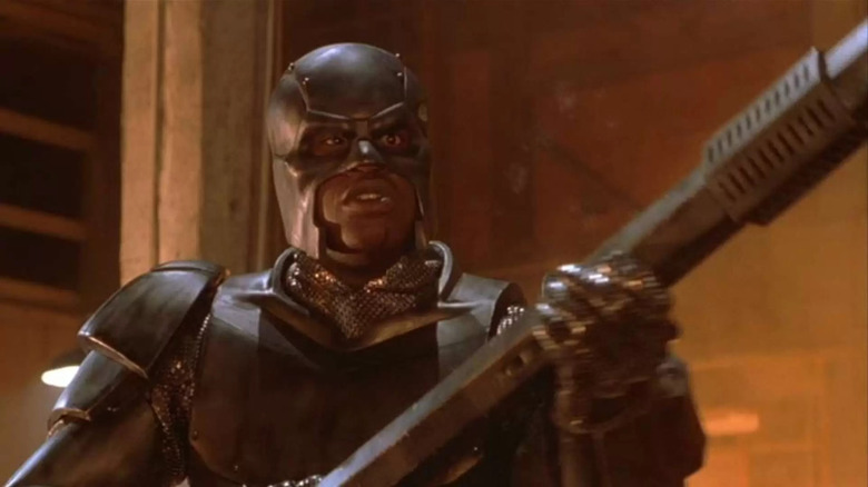 Steel holding a big rod in the movie Steel.