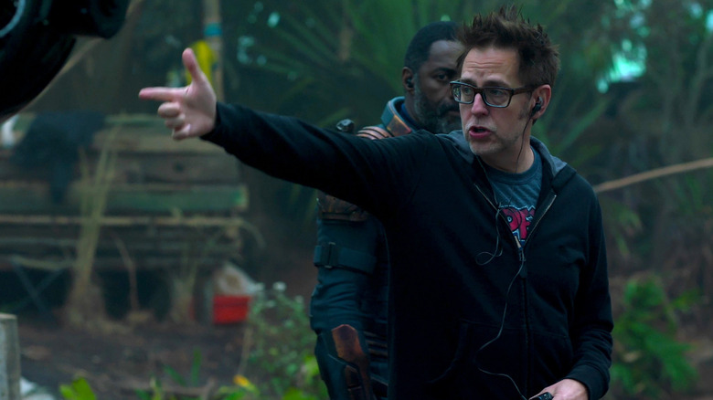 James Gunn pointing with Idris Elba in the background on set