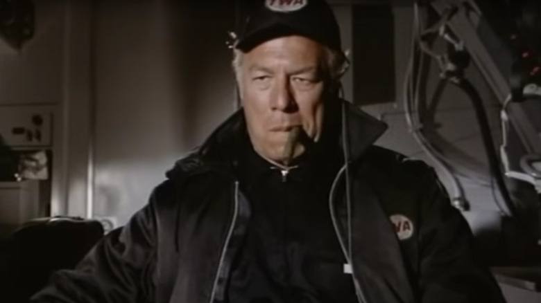George Kennedy's Joe Petroni looking serious and smoking a cigar in Airport