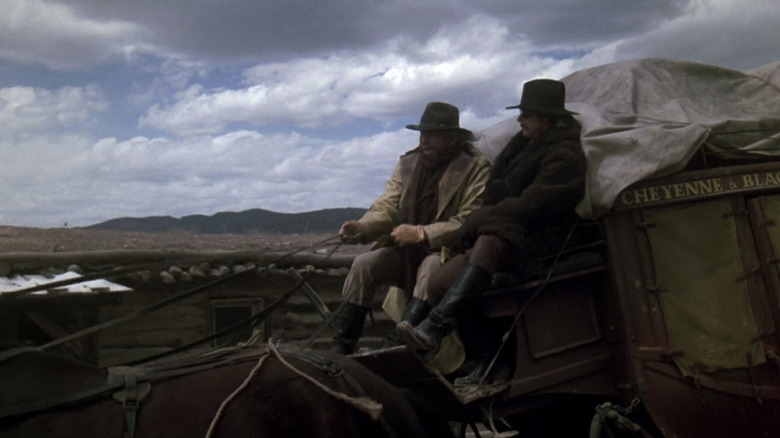 Charles Bronson's Wild Bill Hickok sits on a horse-drawn carriage alongside Will Sampson's Crazy Horse in The White Buffalo