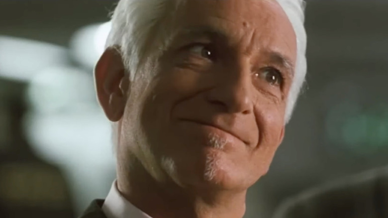 Ben Kingsley as Charles Hatton cocking his head and smiling in A Sound of Thunder