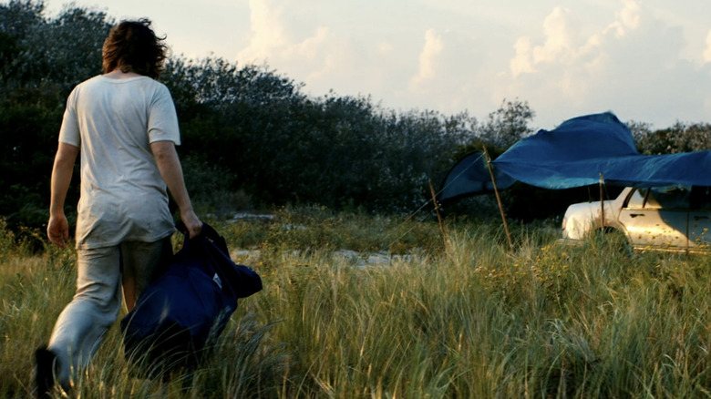 Macon Blair's Dwight Evans walks towards a car in Blue Ruin
