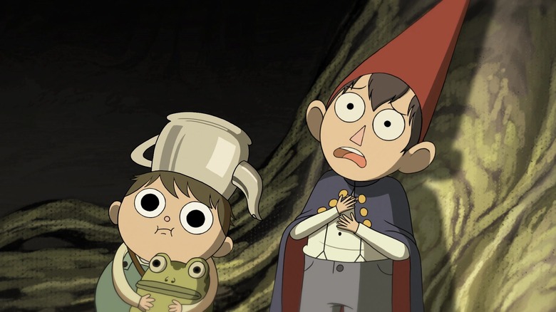 Wirt and Greg looking scared while in a dark forest in Over the Garden Wall