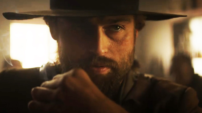 Douglas Booth's Red Bill is seen in closeup as he sits in a saloon in That Dirty Black Bag