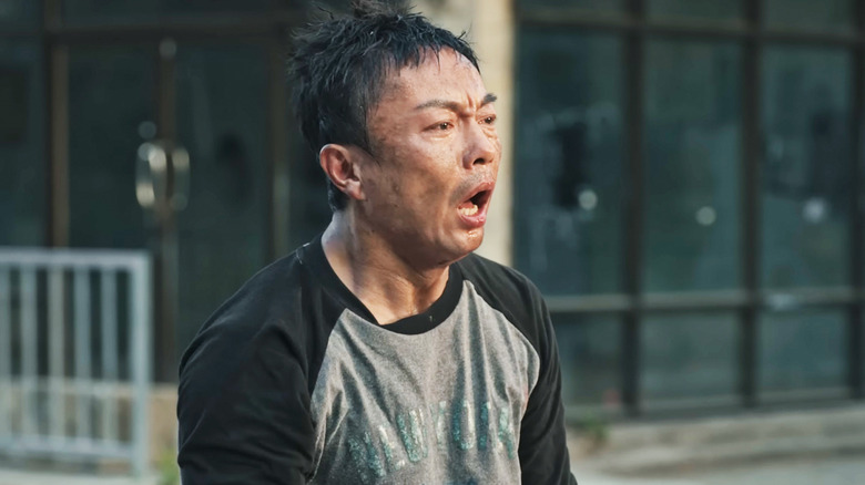 Xie Miao's Wang Wei stands exhausted in a street in The Furious