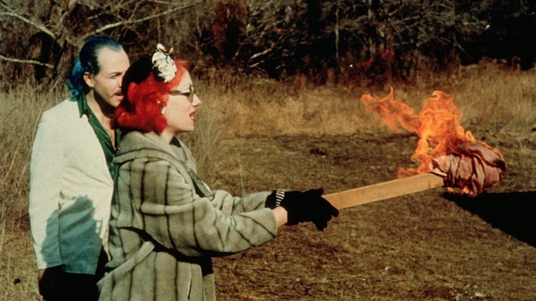 Raymond and Connie Marble with a torch in Pink Flamingos