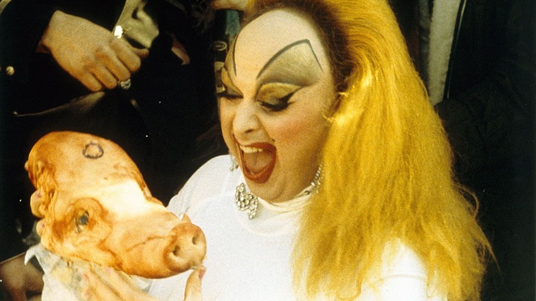 Babs excitedly holding a pig's head in Pink Flamingos