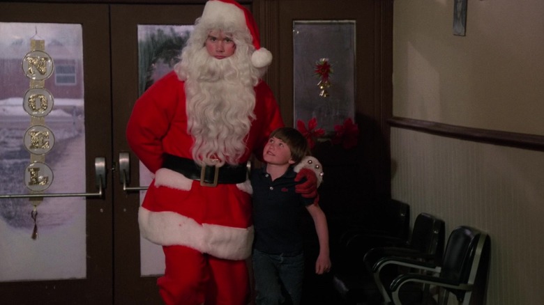 Billy, dressed as Santa, with his arm around a boy in Silent Night, Deadly Night