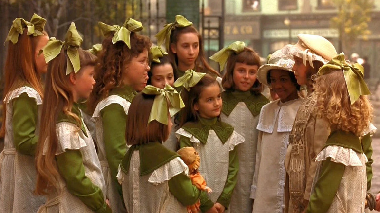 A group of girls around Sarah in A Little Princess