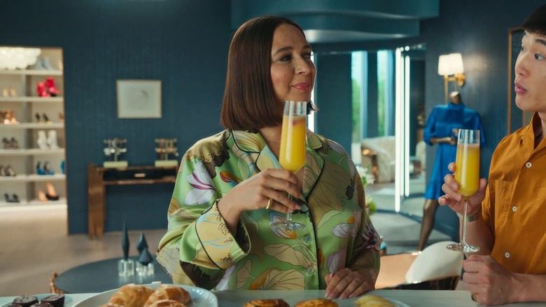 Molly holding a mimosa and talking to Nicholas on Loot