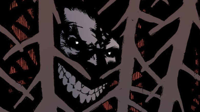 Batman #35 - Joker in the shadows of forest, grinning evilly