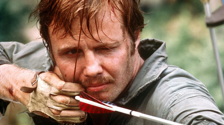 Jon Voight's Ed Gentry aiming with a bow and arrow in Deliverance
