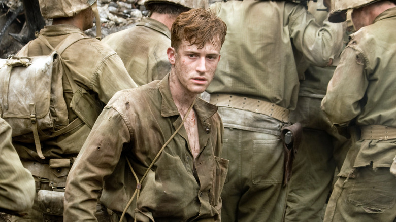 Eugene Sledge surrounded by other soldiers on the march in The Pacific