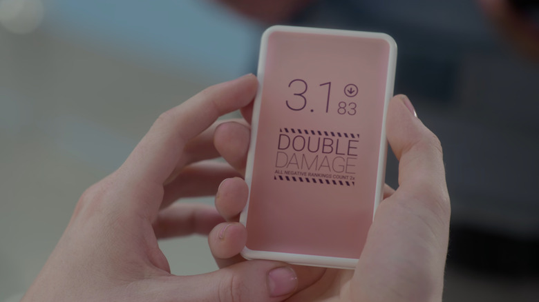 Black Mirror, Noseedive, a Lassi phone snapshot where its social credit rating decreased to 3.1. The screen reads double damage: all negative classifications are calculated 2x.
