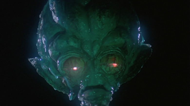 A weird big alien-looking head in The Boxer's Omen