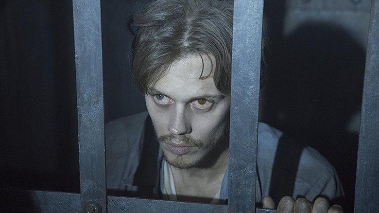 Bill Skarsgard as The Kid behind bars in prison in Castle Rock