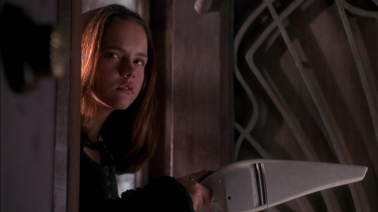 Kat holding out a handheld vacuum cleaner in Casper