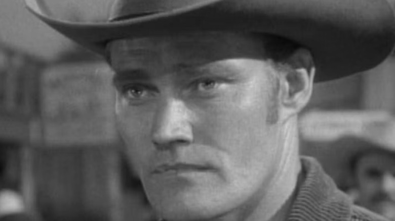 Lucas McCain (Chuck Connors) listens to the concerns of a visitor during The Rifleman