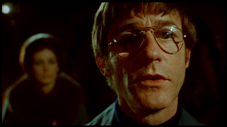 Roddy McDowell as Benjamin Franklin Fischer senses a presence in The Legend of Hell House