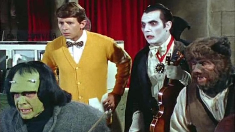 Frank, Walt, Dracula, and Bruce in a basement looking at something in Monster Squad