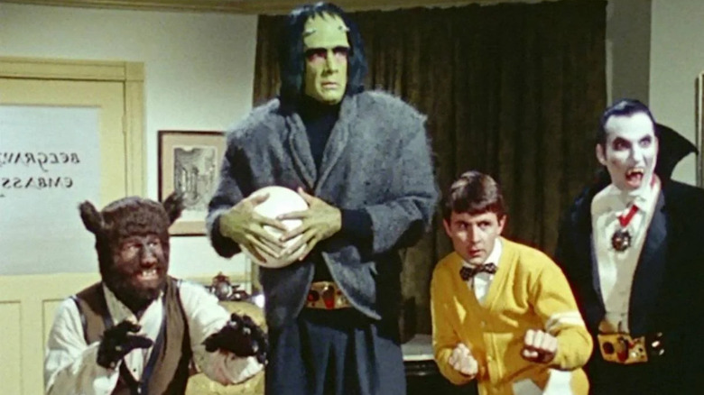 Bruce, Frank, Walt, and Dracula looking ready to fight in an office in Monster Squad