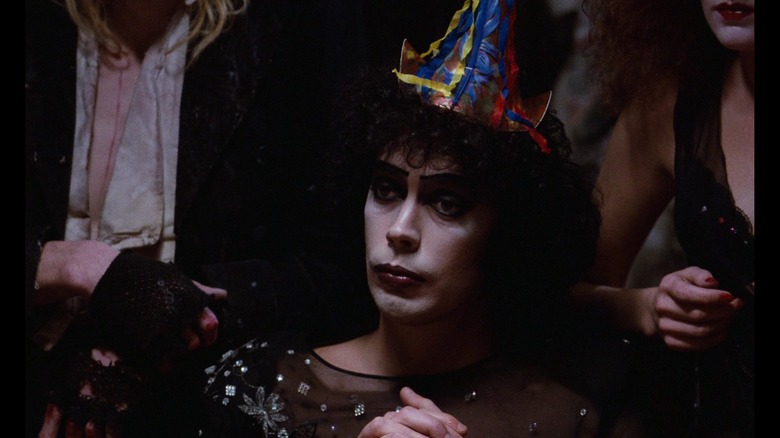 Dr. Frank-N-Furter in a party hat in The Rocky Horror Picture Show