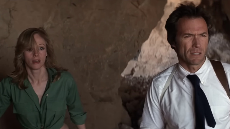Clint Eastwood's Ben Shockley stands in front of Sondra Locke's Augustina Mally in a cave in The Gauntlet