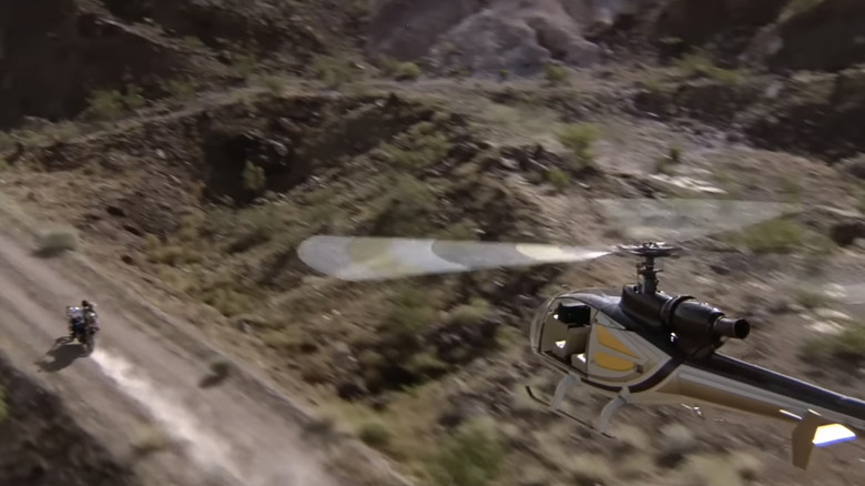 Clint Eastwood's Ben Shockley and Sandra Locke's Augustina Mally ride through the desert on a motorbike while a helicopter pursues them in The Gauntlet