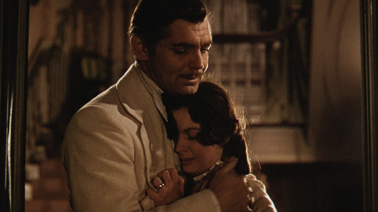 Clark Gable as Rhett Butler embraces Vivien Leigh as Scarlett O'Hara in Gone with the Wind
