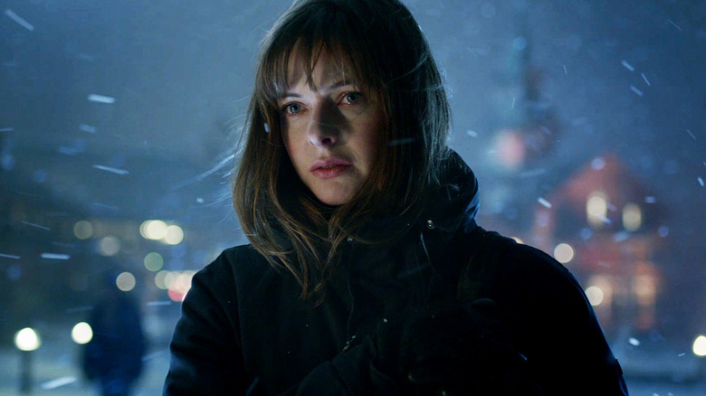 Rebecca Ferguson's Katrine Bratt stands in a snowstorm in The Snowman