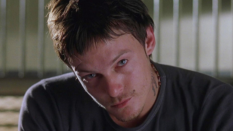 Murphy (Norman Reedus) tilting his head in 