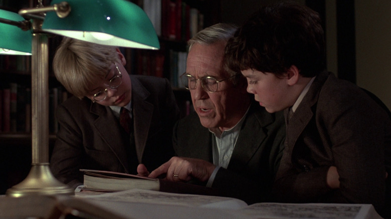 Will, Charles, and Jim pour over a book in Something Wicked This Way Comes