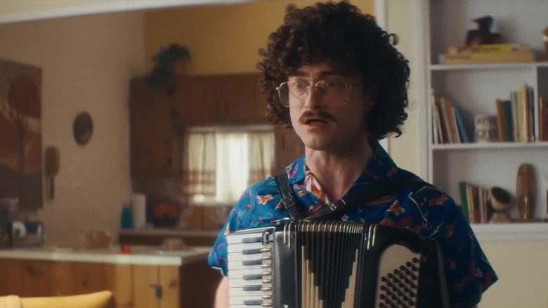 Al playing an accordion in Weird