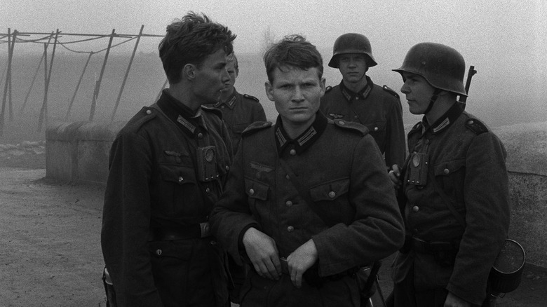Several teens, in Nazi military uniforms on a bridge in The Bridge