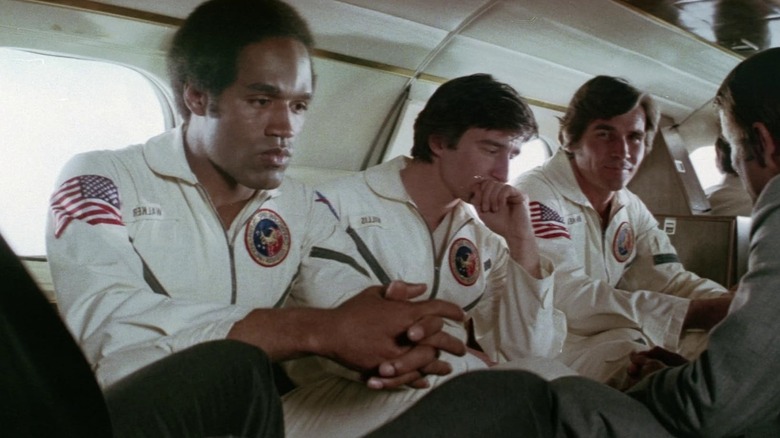 John, Peter, and Charles wearing spacesuits in Capricorn One