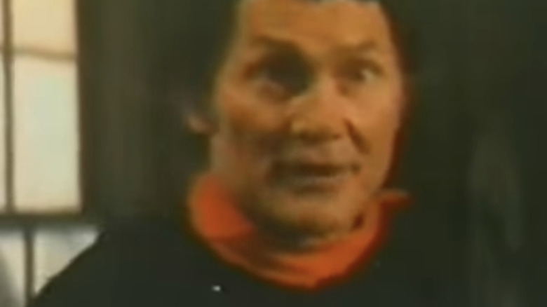 Jack Palance's Frendlander goes wide eyed in closeup in Welcome to Blood City