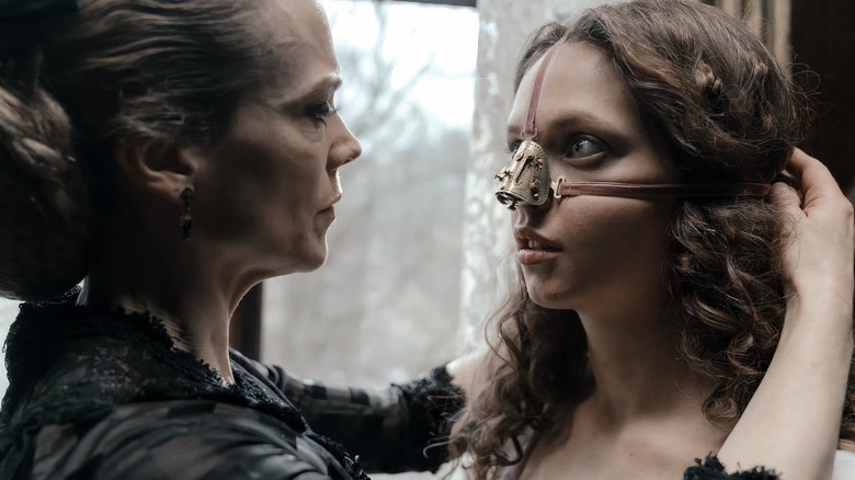 Rebekka adjusting Elvira's nose cage in The Ugly Stepsister