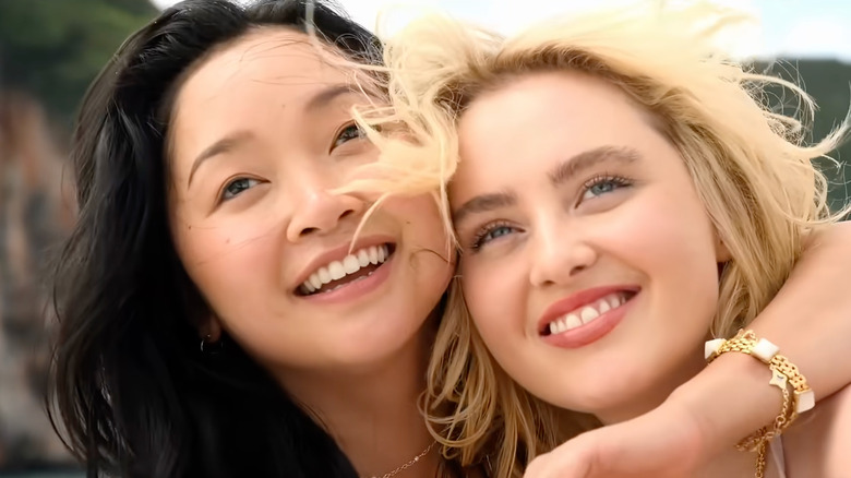 Lana Condor as Max Leviton and Kathryn Newton as Sara McKenna smiling and hugging each other in The Devil's Mouth