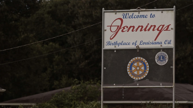 A welcome sign for Jennings Louisiana is seen against some trees in Murder in the Bayou
