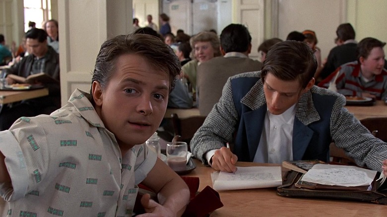 Marty and George sitting in a school cafeteria in Back to the Future