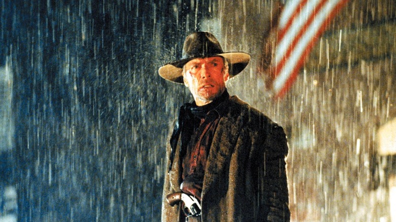 Clint Eastwood's Will Munny looking mean with a pistol in his belt in the finale of Unforgiven